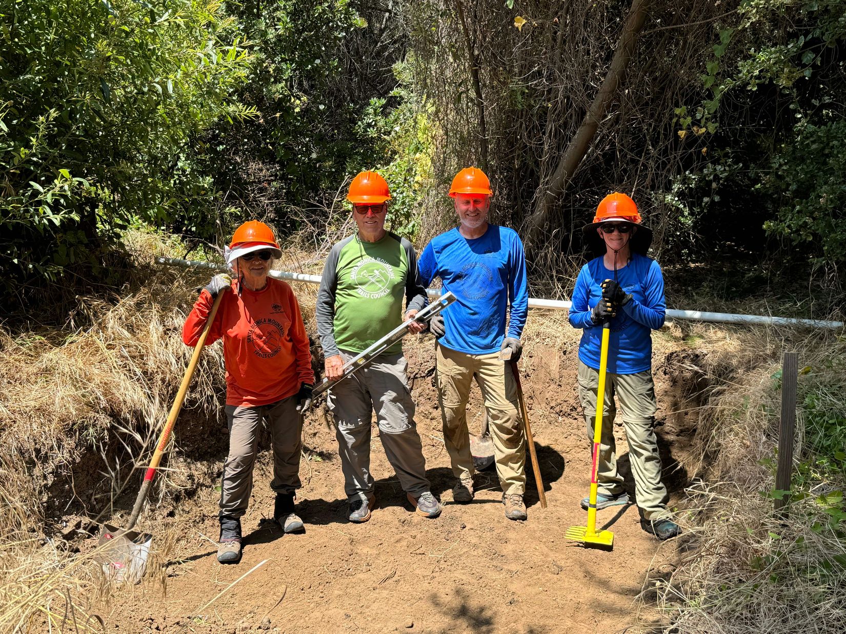 Crew posing  in toilet pit during construction - Carlyn, Dave, John & Ruth