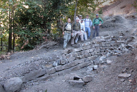 The wall grows taller with each passing week. view of volunteers and work area