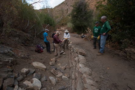 Looking down the trail from the wall view of volunteers and work area